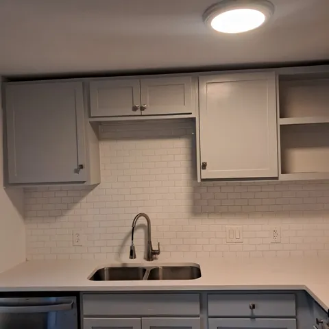 a kitchen with microwave cabinets and a stove top oven