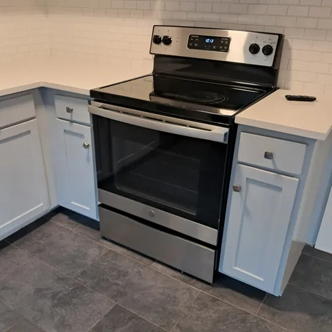 en empty room with wooden floor and fan