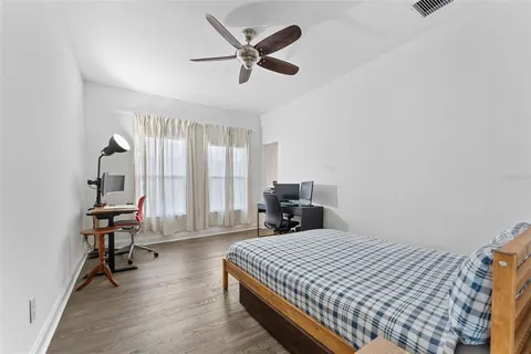 a bed room with a bed and a chair