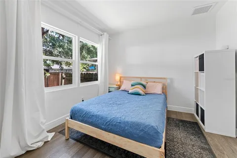 a bedroom with a bed and window