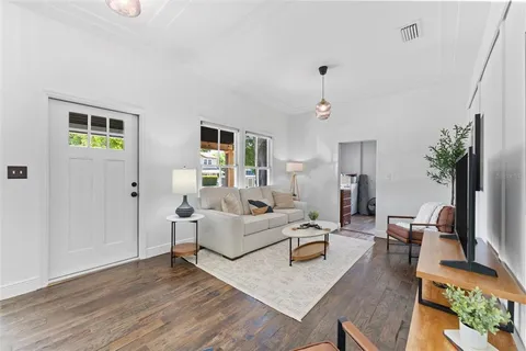 a living room with furniture flat screen tv and a fireplace