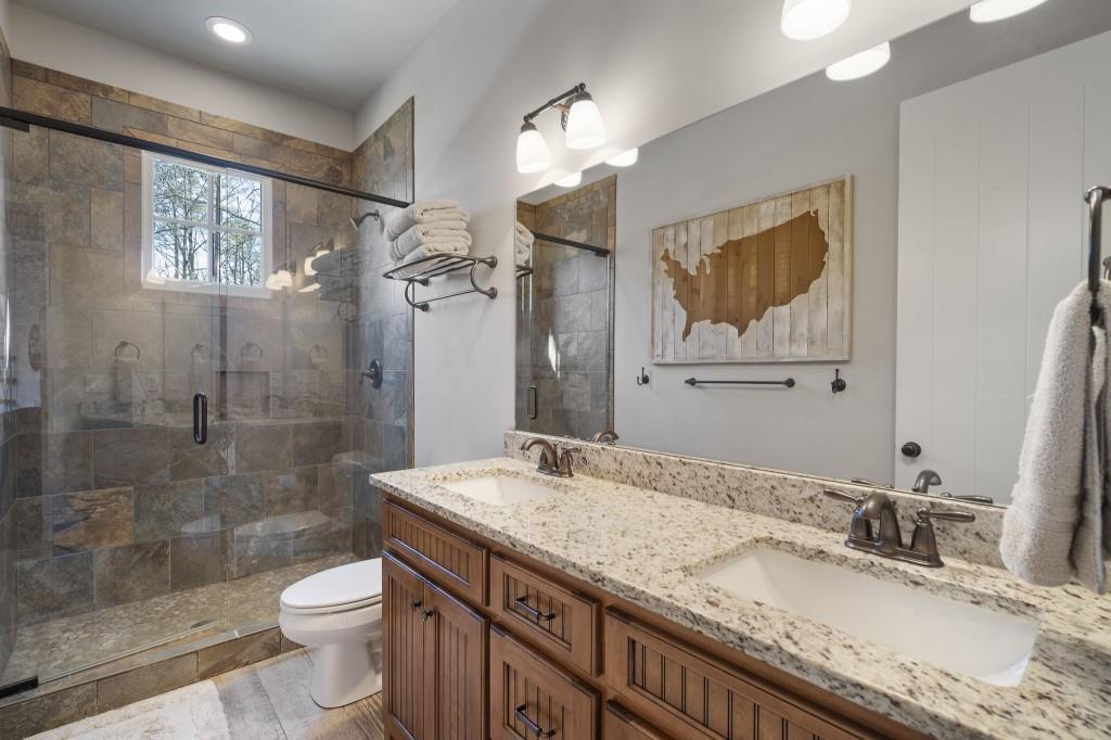 72 Buckeye Ridge Newnan, GA 30263 - Photo 42 of 80 a bathroom with a granite countertop sink toilet and shower