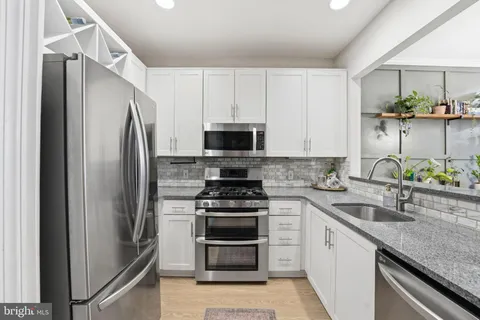 a kitchen with a sink stove and refrigerator