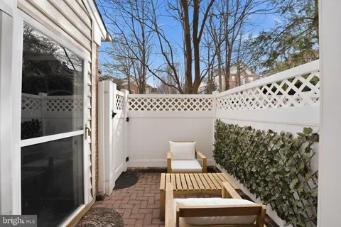 a view of a porch with wooden floor and fence