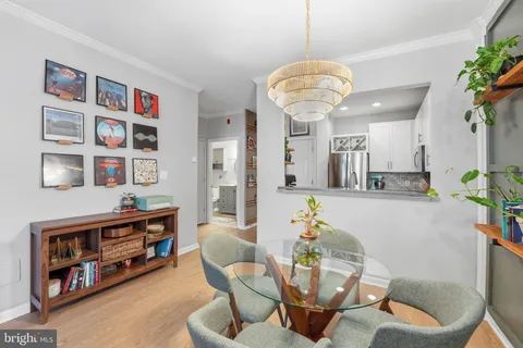 a living room with furniture a bookshelf and a chandelier
