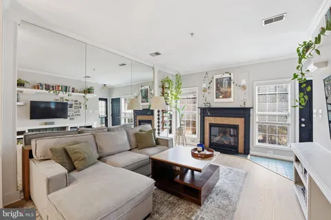 a living room with fireplace furniture and a chandelier