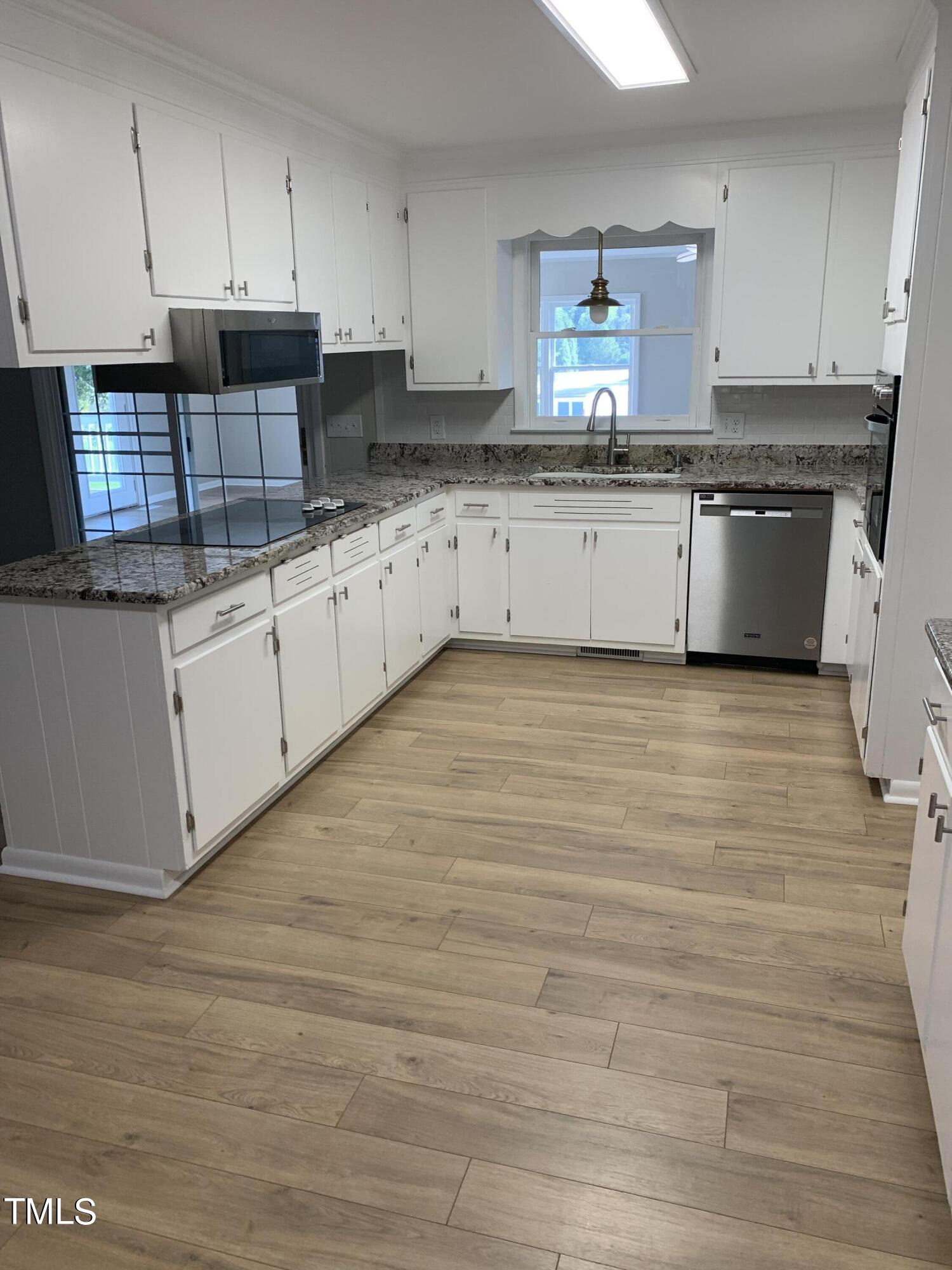 182 Old Lystra Road Chapel Hill, NC 27517 - Photo 12 of 17 a kitchen with granite countertop a sink a stove top oven and cabinets