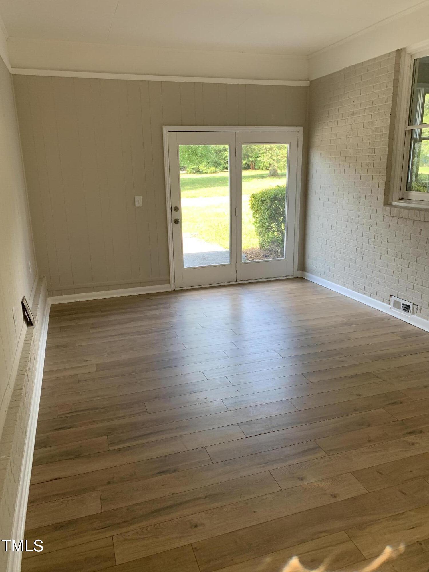 182 Old Lystra Road Chapel Hill, NC 27517 - Photo 7 of 17 a view of an empty room with wooden floor and a window