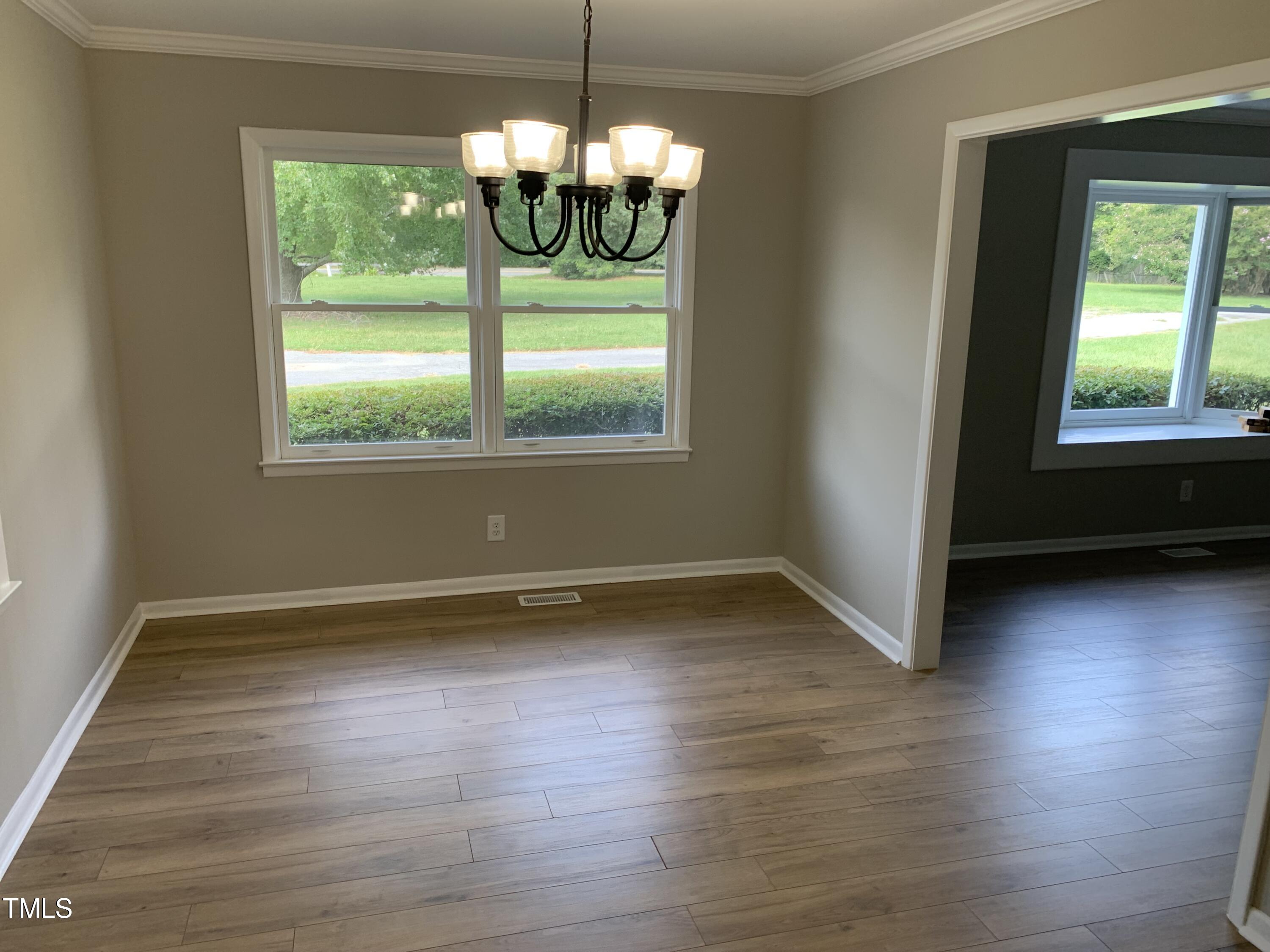 182 Old Lystra Road Chapel Hill, NC 27517 - Photo 8 of 17 a view of an empty room with wooden floor and a window