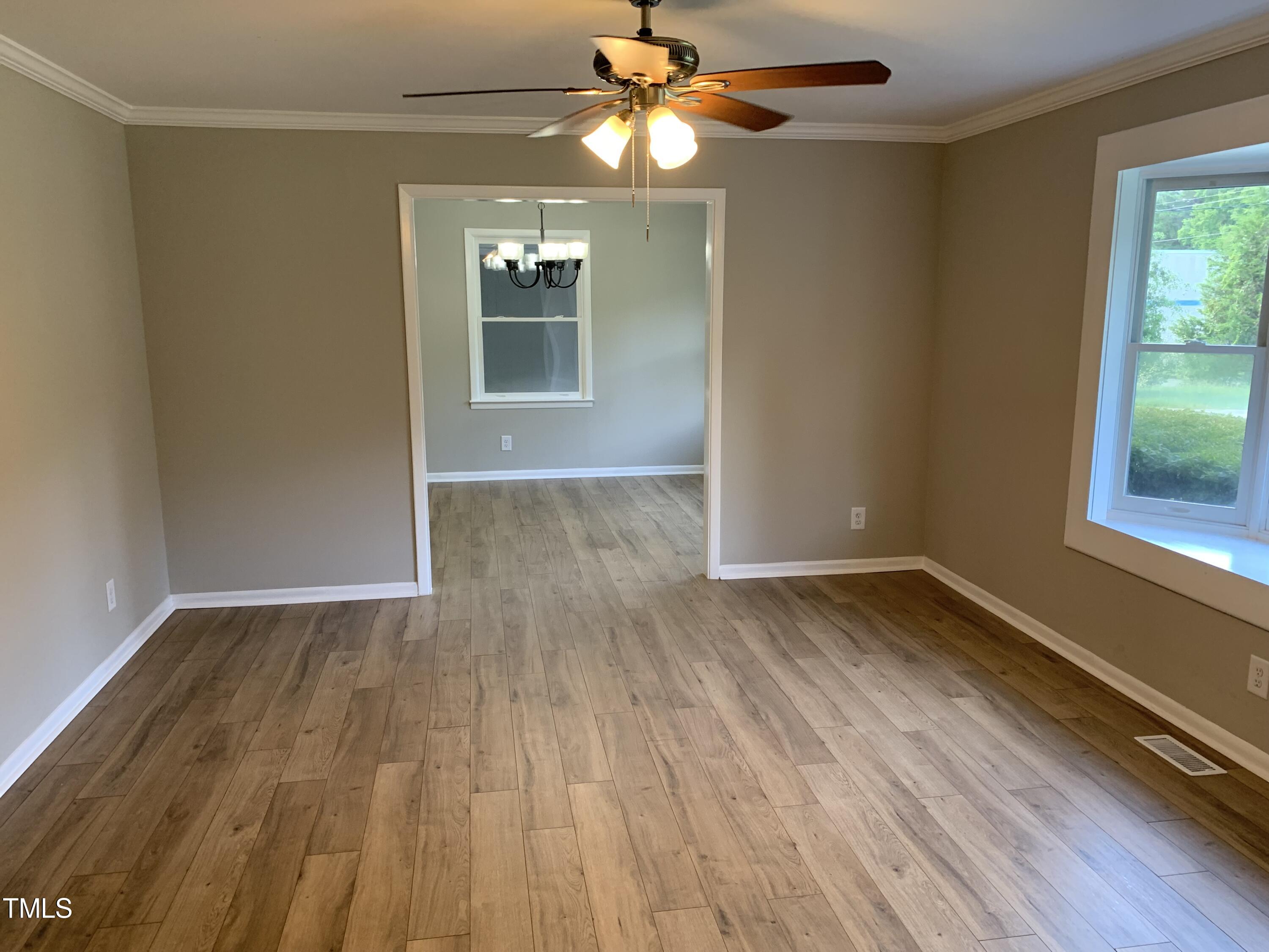 182 Old Lystra Road Chapel Hill, NC 27517 - Photo 9 of 17 a view of empty room with wooden floor and fan