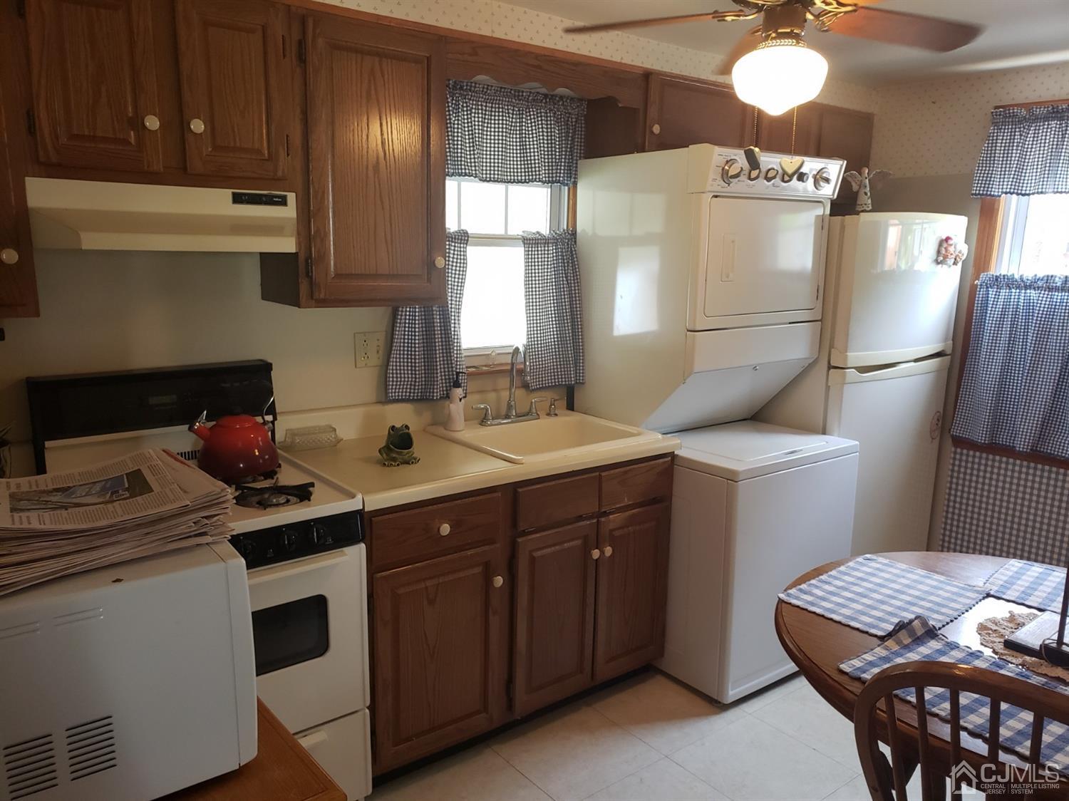 53 West Cliff Road Colonia, NJ 07067 - Photo 9 of 12 Kitchen with laundry. Side door to patio.