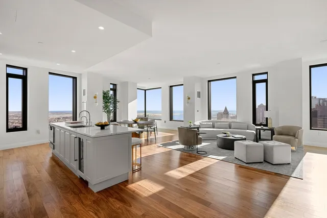 a living room with fireplace furniture and a large window