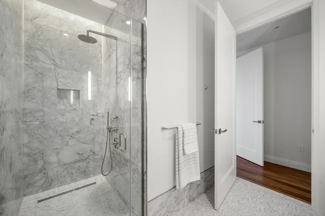 a bathroom with a shower and a glass door
