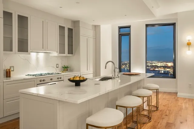 a kitchen with a sink a stove and chairs