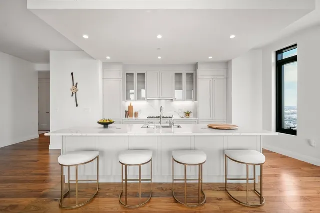 a kitchen with lots of counter space and chairs