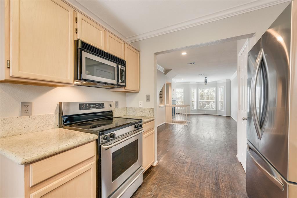 2902 State Street, Unit 1 Dallas, TX 75204 - Photo 11 of 24 a kitchen with stainless steel appliances granite countertop a stove a microwave and a refrigerator