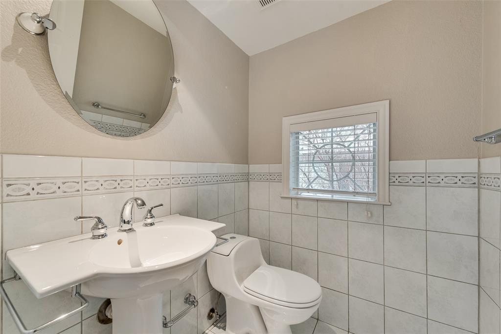 2902 State Street, Unit 1 Dallas, TX 75204 - Photo 12 of 24 a bathroom with a sink a mirror and a toilet