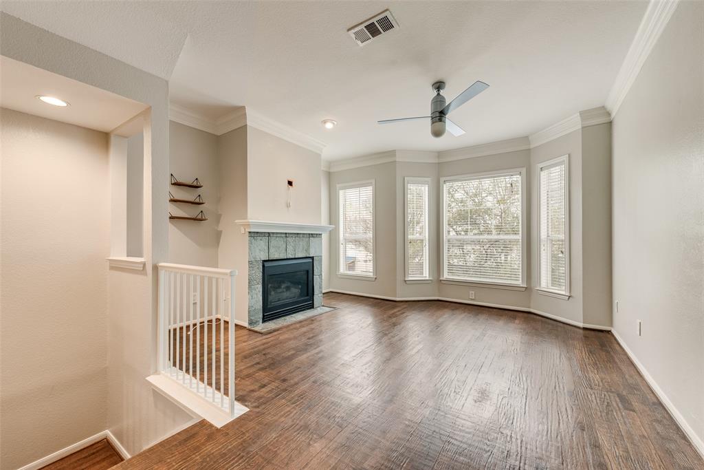 2902 State Street, Unit 1 Dallas, TX 75204 - Photo 6 of 24 an empty room with wooden floor fireplace and windows