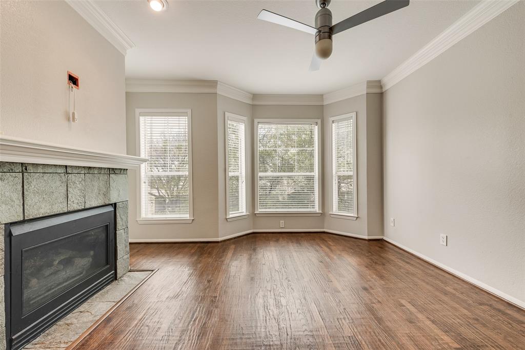 2902 State Street, Unit 1 Dallas, TX 75204 - Photo 9 of 24 a view of an empty room with wooden floor fireplace and a window