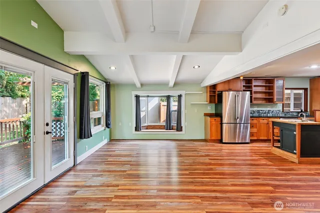 a view of livingroom with kitchen and wooden floor
