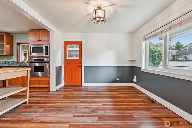 a living room with furniture a flat screen tv and a floor to ceiling window