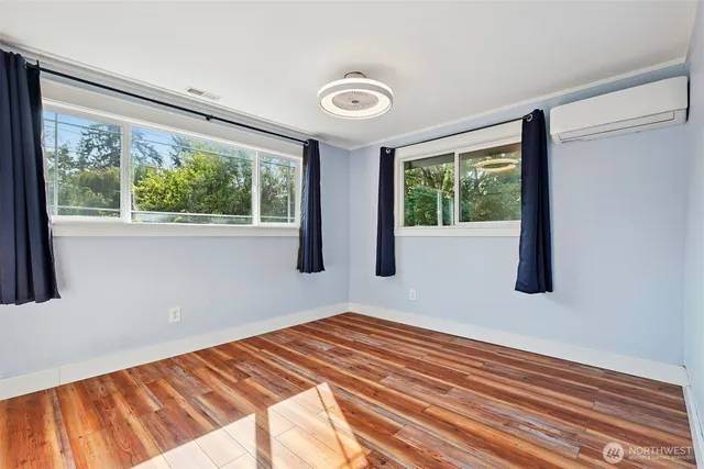 a view of a room with wooden floor and windows