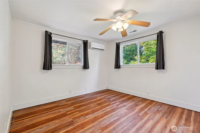 a view of a hallway with wooden floor and entryway