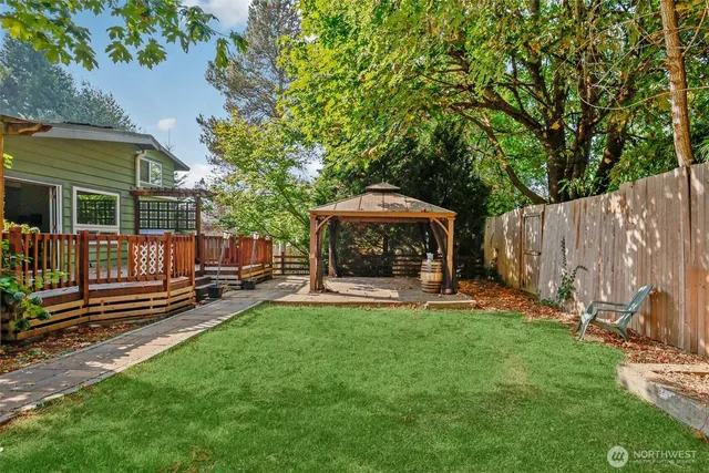 front view of a house with a yard and large trees