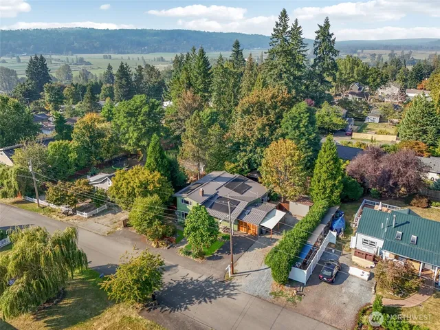 an aerial view of a city with lots of residential buildings and mountain view in back