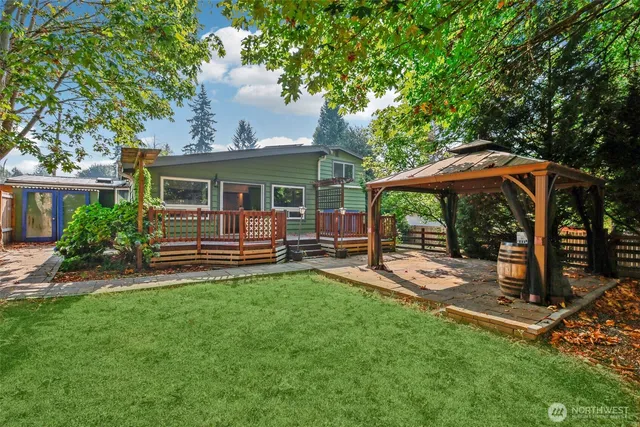 a view of a house with a backyard and a patio