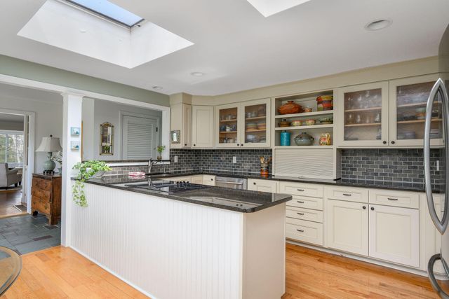 a kitchen with stainless steel appliances granite countertop a refrigerator and a stove