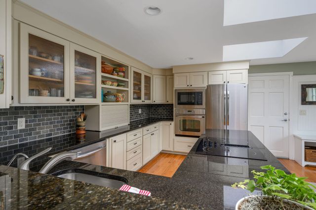 a kitchen with granite countertop lots of counter top space and dining table