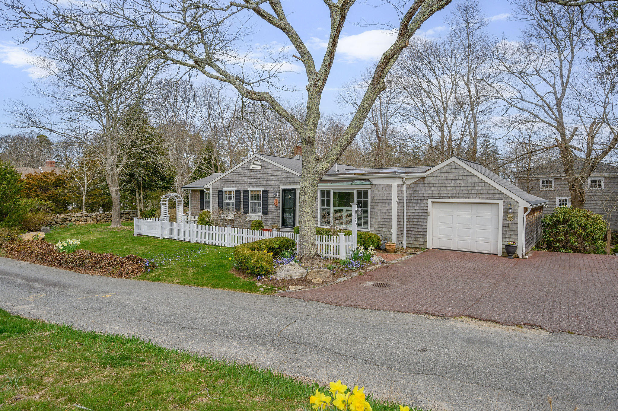 26 Beale Way Barnstable, MA 02630 - Photo 47 of 64 a front view of a house with garden and trees
