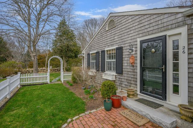 a front view of a house with a yard table and chairs