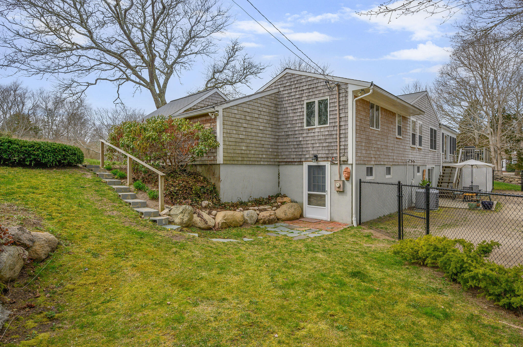 26 Beale Way Barnstable, MA 02630 - Photo 56 of 64 a backyard of a house with table and chairs