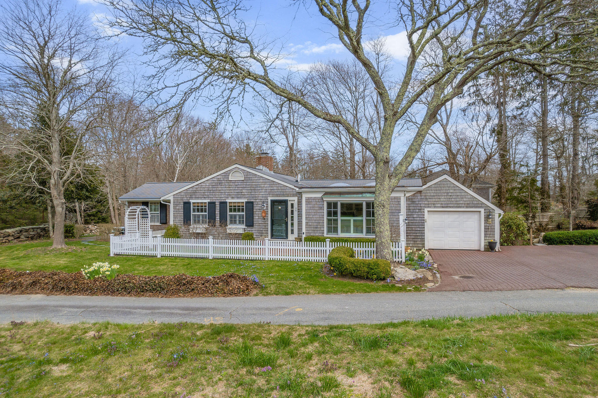 26 Beale Way Barnstable, MA 02630 - Photo 63 of 64 a front view of a house with a garden and trees