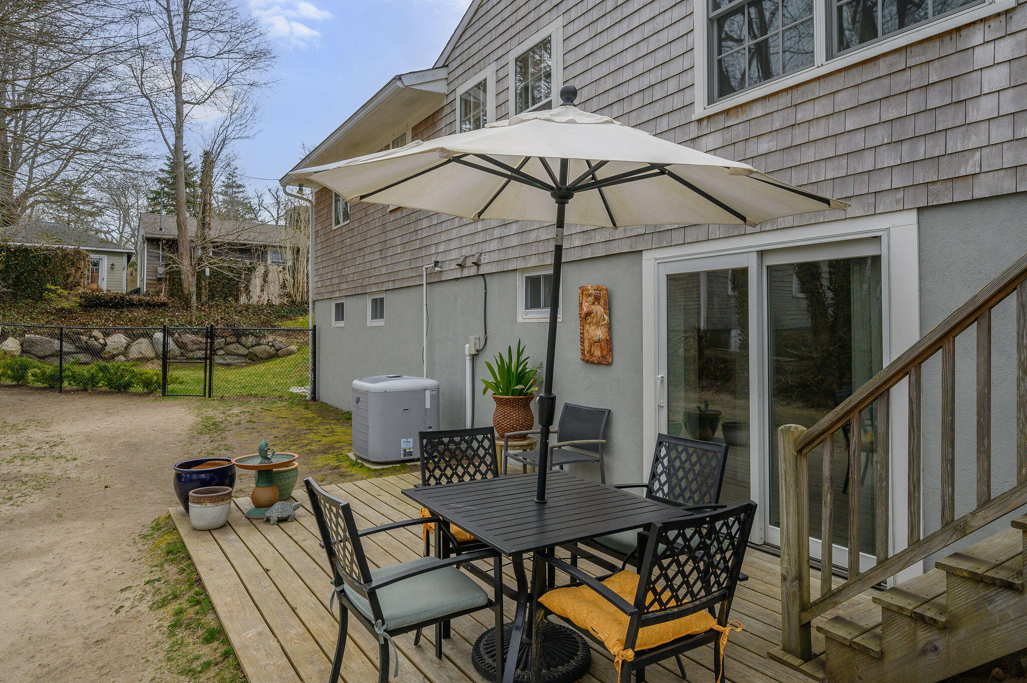 26 Beale Way Barnstable, MA 02630 - Photo 7 of 64 a view of a patio with table and chairs under an umbrella