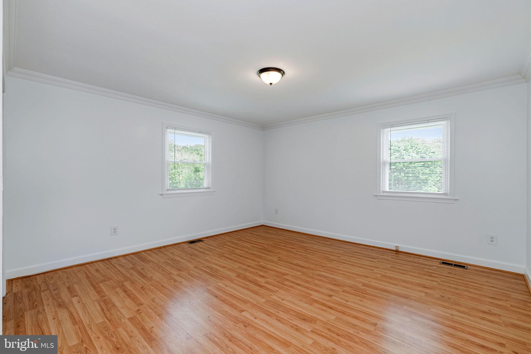 11325 Bacon Race Road Woodbridge, VA 22192 - Photo 26 of 54 a view of an empty room with wooden floor and a window