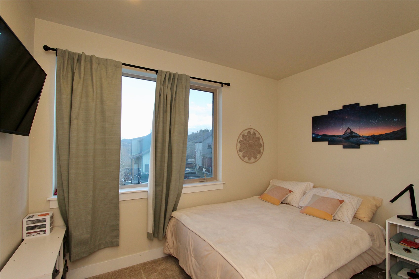 54 Haymaker Street, Unit 54 Silverthorne, CO 80498 - Photo 11 of 21 a bedroom with a bed and a flat tv screen on dresser