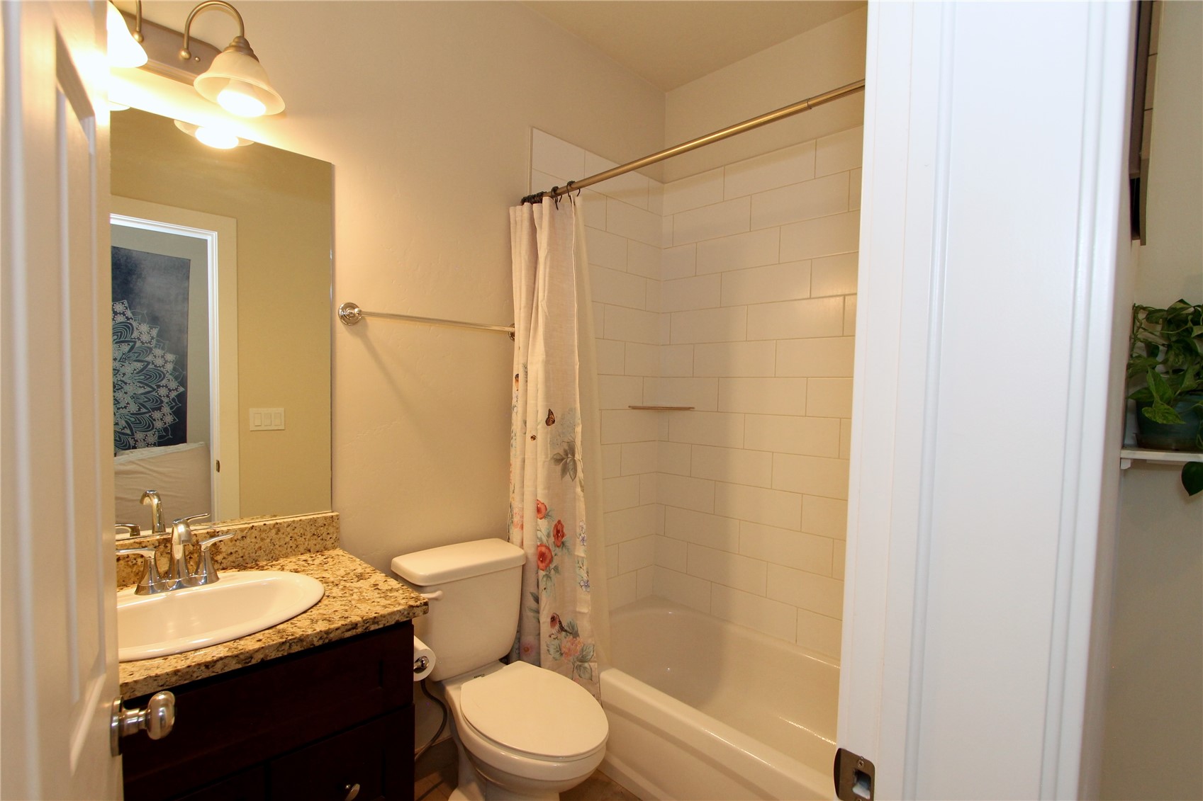 54 Haymaker Street, Unit 54 Silverthorne, CO 80498 - Photo 18 of 21 a bathroom with a granite countertop sink toilet mirror and shower