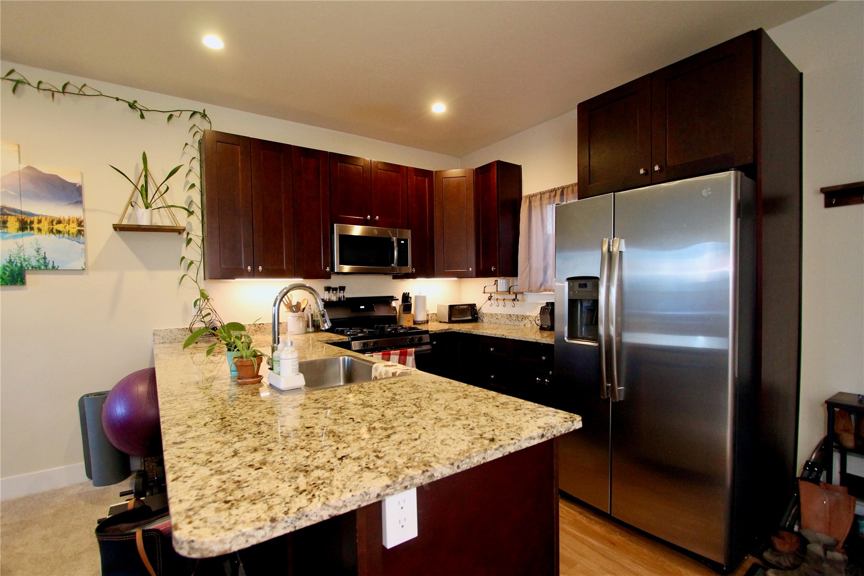 54 Haymaker Street, Unit 54 Silverthorne, CO 80498 - Photo 21 of 21 a kitchen with a refrigerator a microwave a sink and cabinets