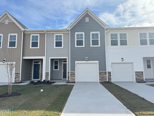 a view of a brick house with a yard