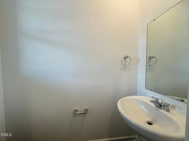 a bathroom with a sink and mirror