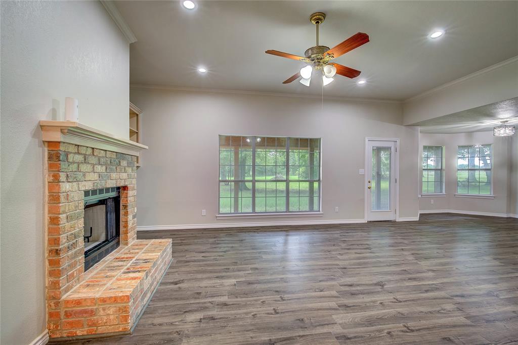 225 Rs County Road 1278 Emory, TX 75440 - Photo 13 of 36 a view of an empty room with wooden floor and a window