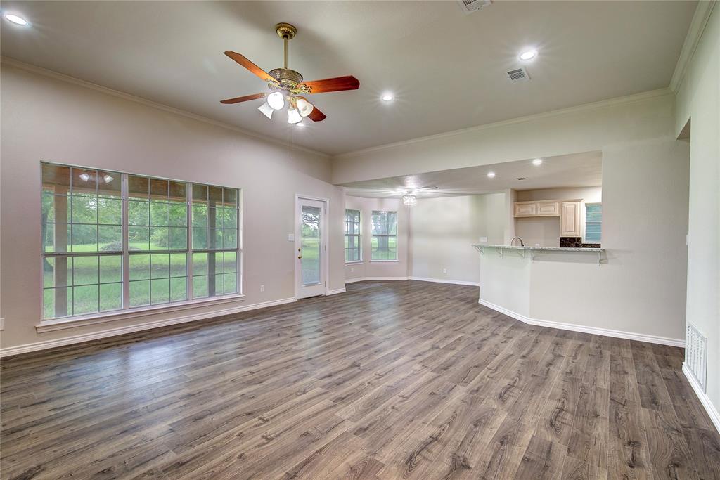 225 Rs County Road 1278 Emory, TX 75440 - Photo 14 of 36 a view of an empty room with wooden floor and a window
