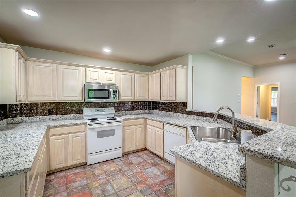 225 Rs County Road 1278 Emory, TX 75440 - Photo 16 of 36 a kitchen with a sink stove and cabinets