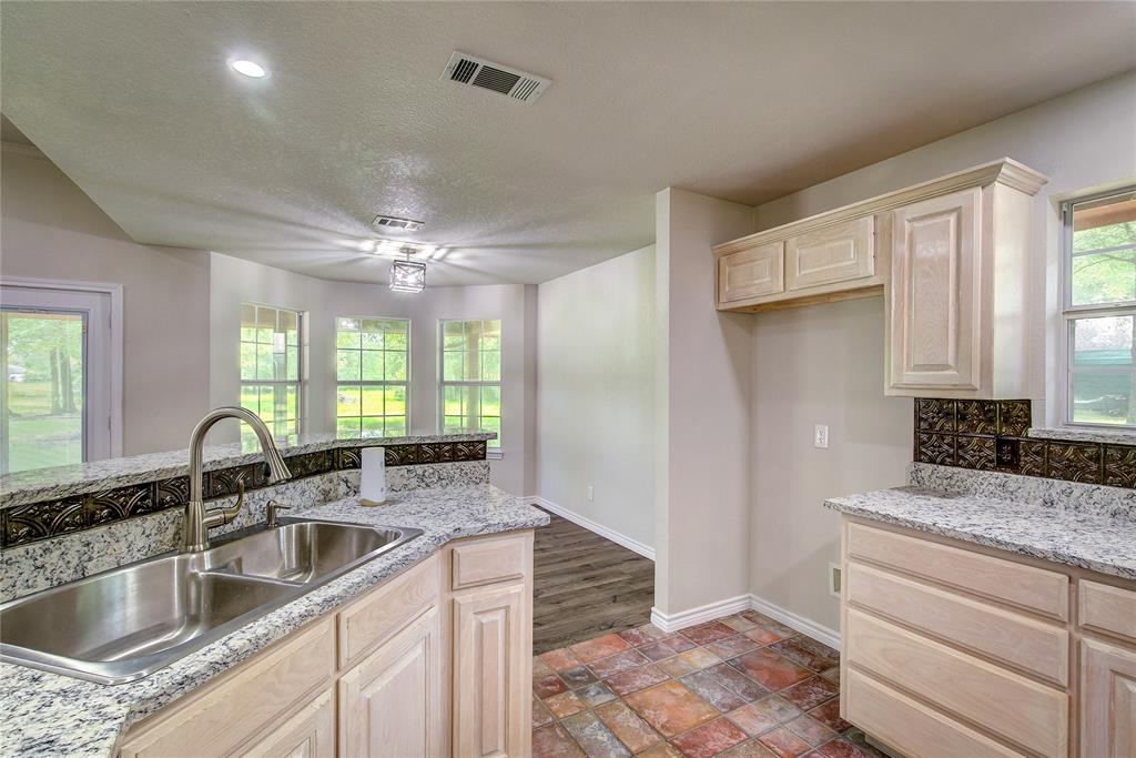 225 Rs County Road 1278 Emory, TX 75440 - Photo 18 of 36 a kitchen with a sink cabinets and window