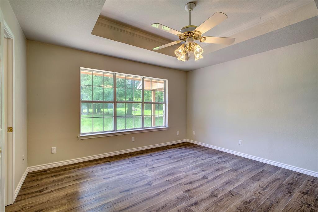 225 Rs County Road 1278 Emory, TX 75440 - Photo 27 of 36 wooden floor in an empty room with a window