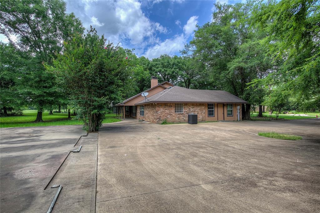 225 Rs County Road 1278 Emory, TX 75440 - Photo 6 of 36 a front view of a house with a yard and trees