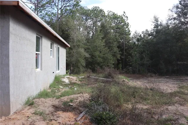 a backyard of a house with lots of green space